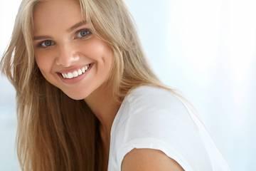 Woman smiling after cosmetic dentistry in Pikesville, MD